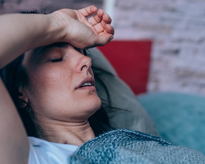 A woman resting with her arm over her head