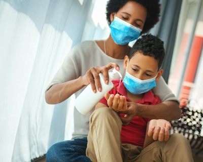 Person in a mask with child in a mask