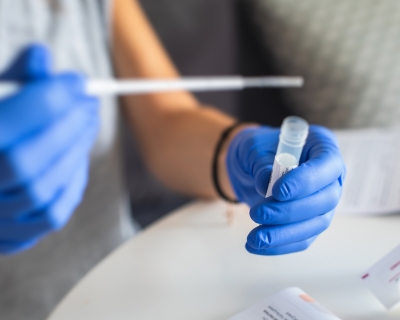 Person holding a COVID-19 Test Tube