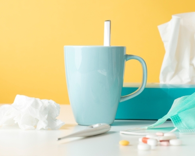 tissue box, coffee mug and thermometer