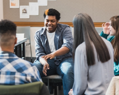 Teenagers at school gathered in a circle talking