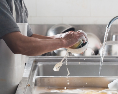 photo of person washing dishes 