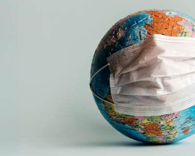 A world globe with a mask on