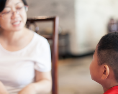 A woman and young boy speaking to each other 