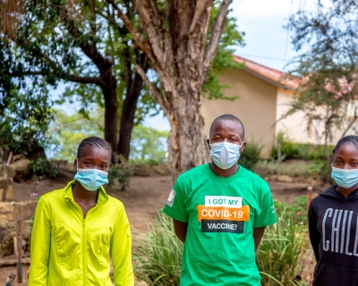 sther Sambiri, left, stands with fellow vaccine advocates outside the Nyanga, Zimbabwe, district government office on Dec. 16, 2021. Image: Farai Mutsaka