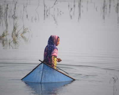 Teenager Hasina Begum fishing in the salty Kholpetua River in southwestern Bangladesh. 