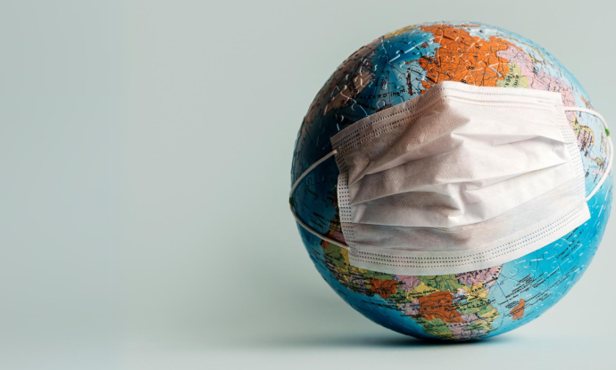 A world globe with a mask on